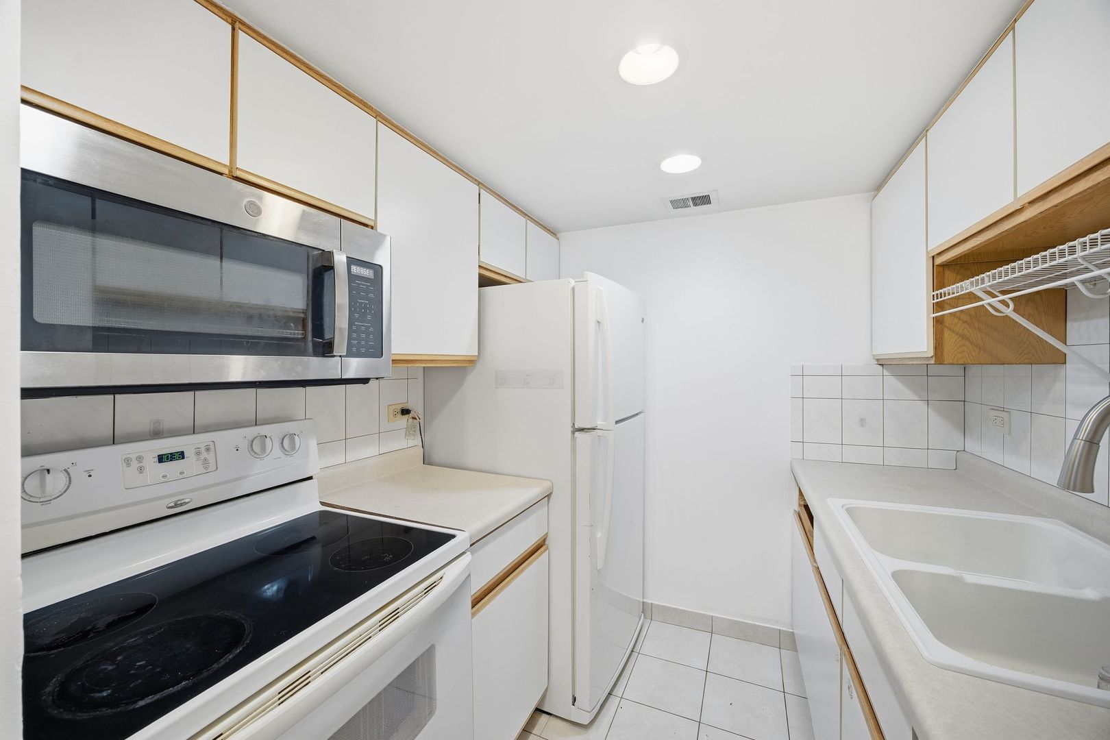 4618 River Road, Unit 1D Schiller Park, IL 60176 - Photo 8 of 12 a kitchen with a refrigerator stove and microwave