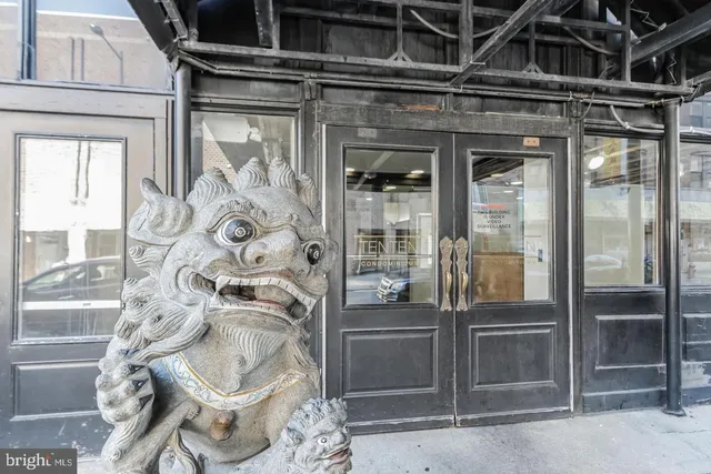 a living room with furniture a fireplace and a chandelier