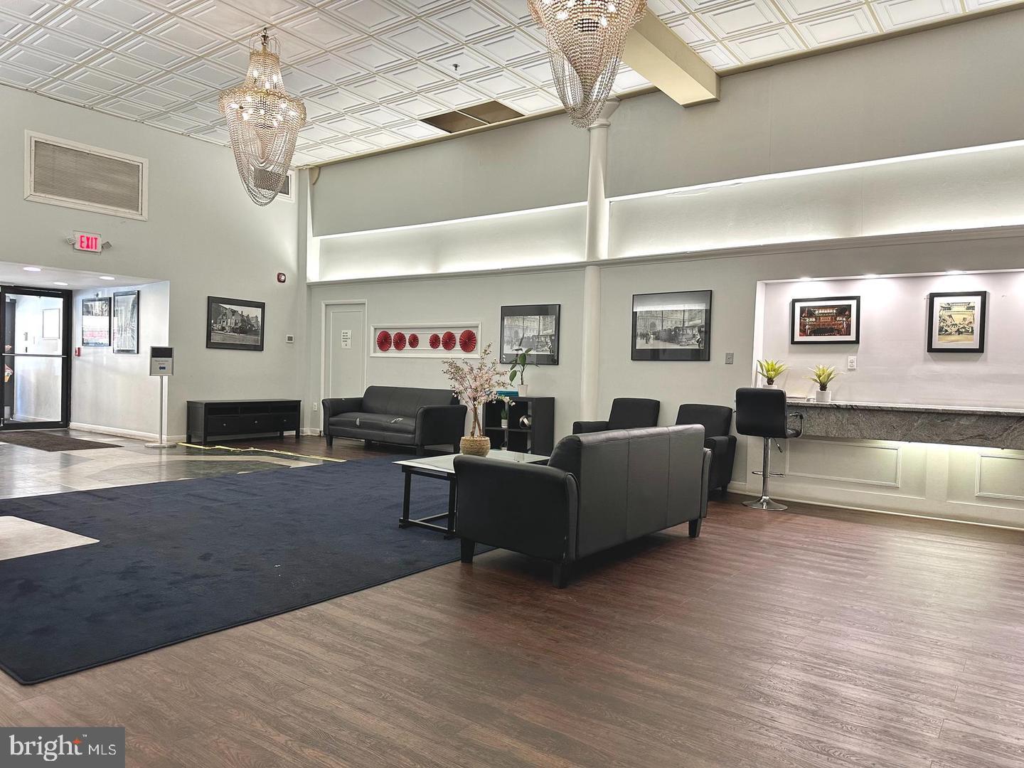 1010 Race Street, Unit 6K Philadelphia, PA 19107 - Photo 4 of 17 a living room with furniture a fireplace and a chandelier