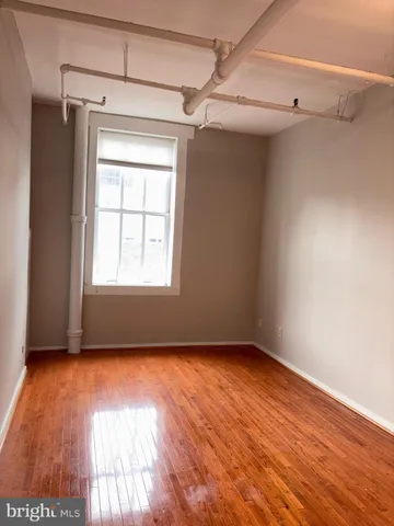 a view of a room with wooden floors and walls