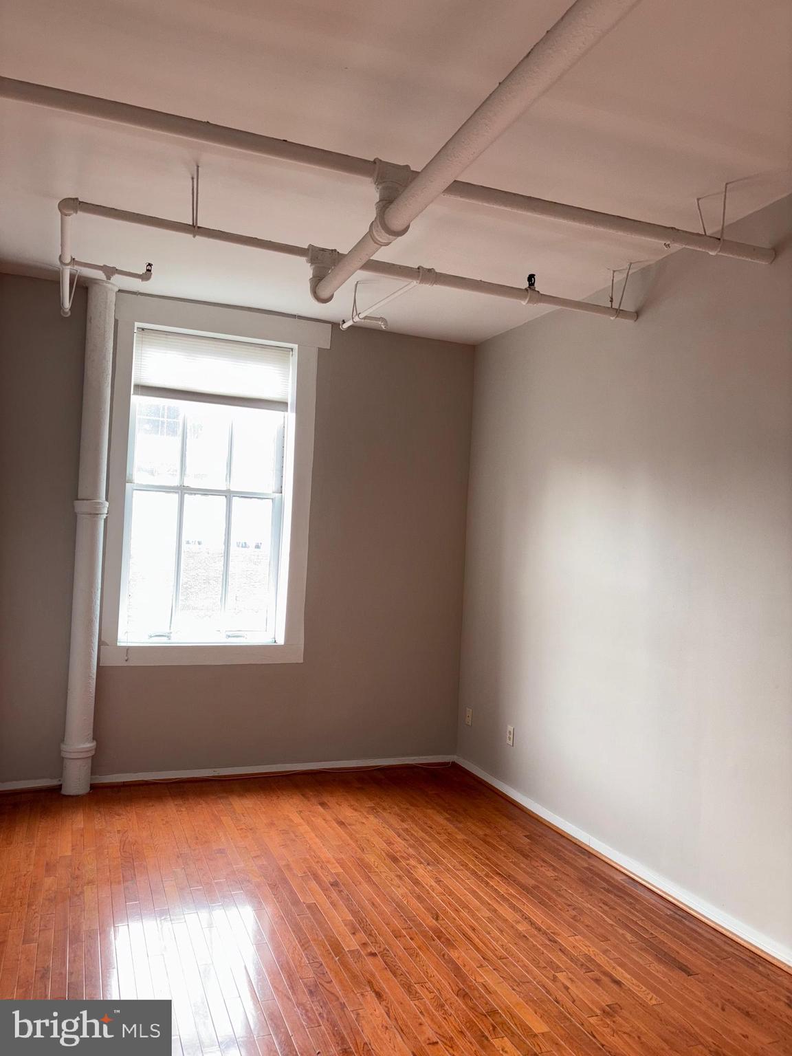 1010 Race Street, Unit 6K Philadelphia, PA 19107 - Photo 7 of 17 a view of a room with wooden floors and walls