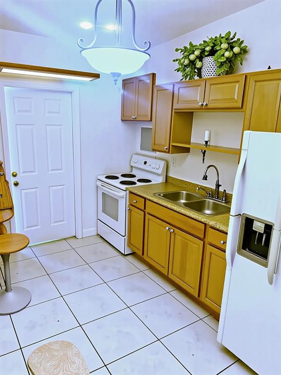 12225 Northwest 17th Avenue North Miami, FL 33167 - Photo 15 of 19 a kitchen with stainless steel appliances granite countertop a sink stove and cabinets