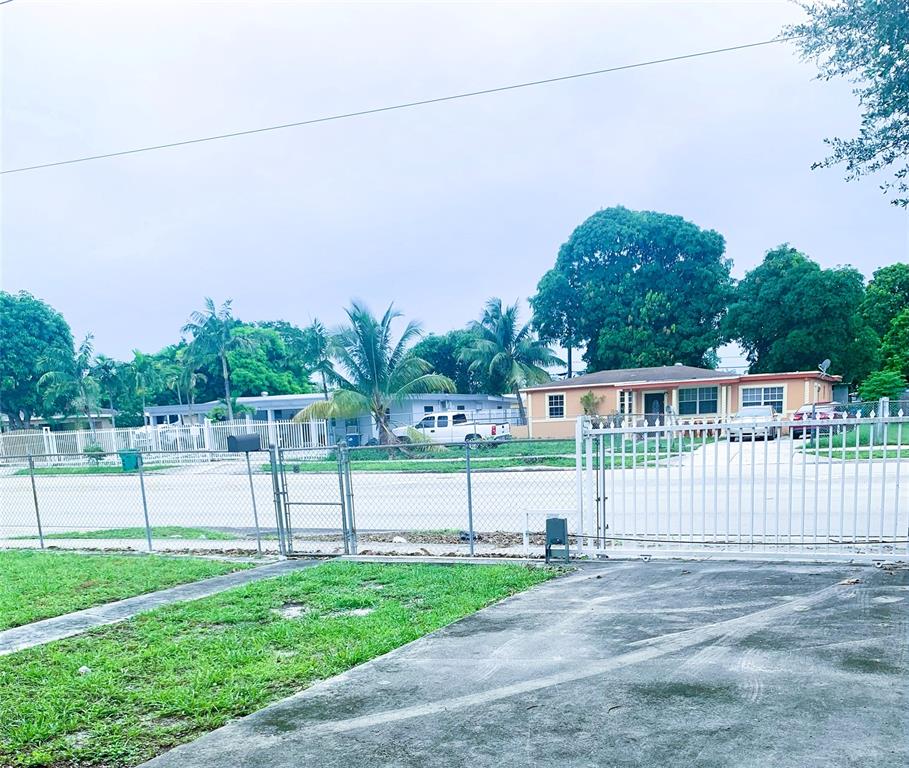 12225 Northwest 17th Avenue North Miami, FL 33167 - Photo 4 of 19 a view of a house with a yard and a fence