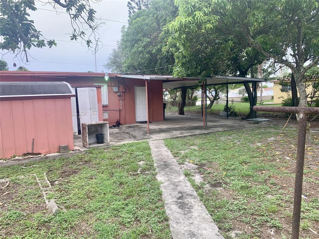 12225 Northwest 17th Avenue North Miami, FL 33167 - Photo 5 of 19 a backyard of a house with lots of green space and fountain
