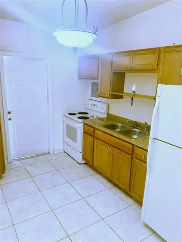 a kitchen with a stove sink and cabinets