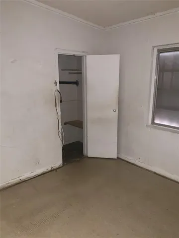 a view of empty room with closet