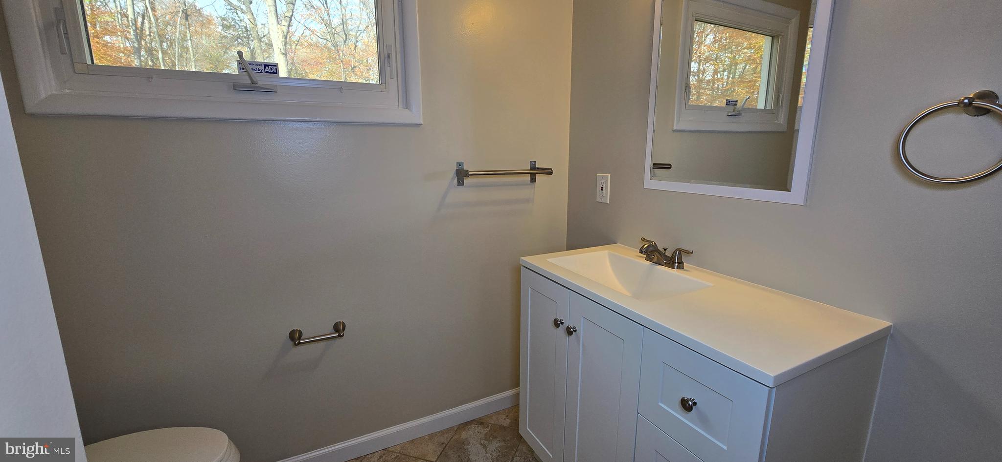 7613 Locust Lane Fort Washington, MD 20744 - Photo 30 of 49 a bathroom with a sink toilet and mirror