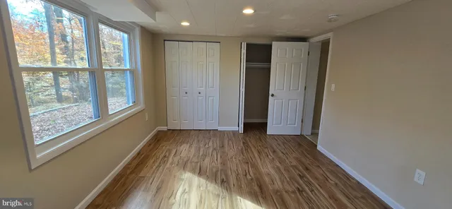 a view of hallway with a large window and wooden floor