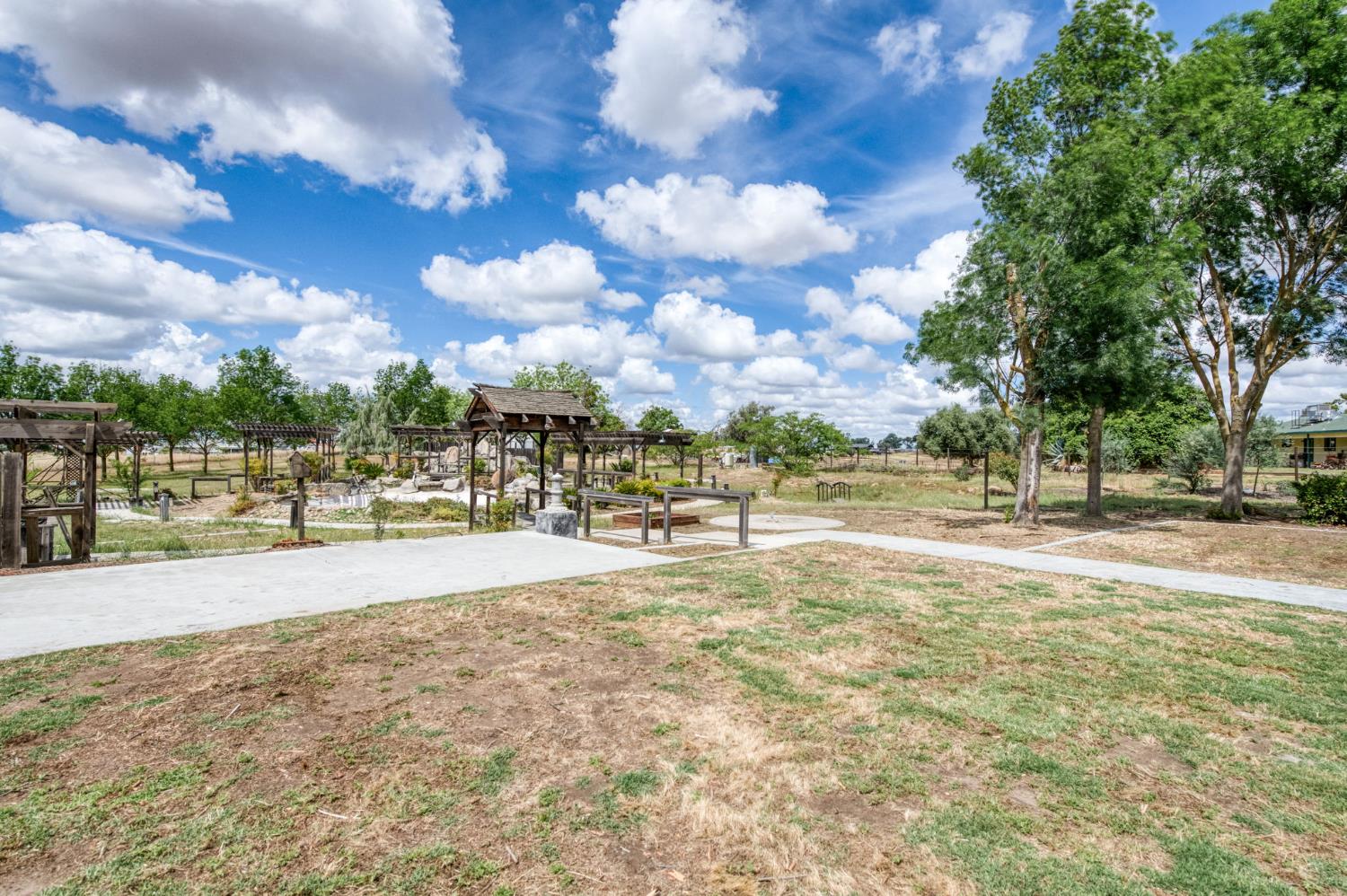 16564 Monreal Road Madera, CA 93636 - Photo 27 of 59 a view of yard with swimming pool and green space