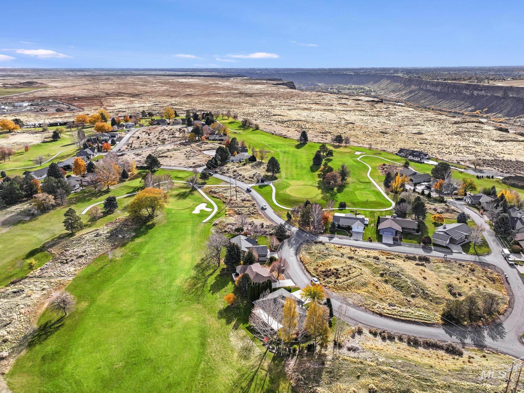 100 Olympic Road Jerome, ID 83338 - Photo 36 of 50 Aerial perspective showcasing a residential area integrated with a golf course, bordered by a canyon landscape