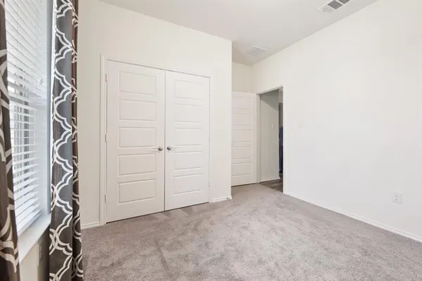 a view of a hallway with wooden floor and entryway