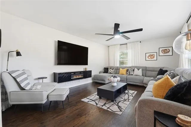 a living room with furniture and a flat screen tv