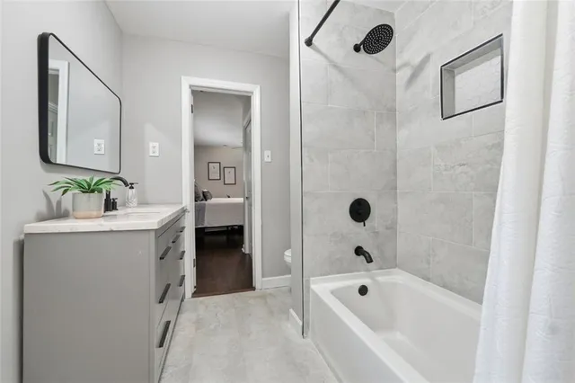 a bathroom with a tub a sink and mirror