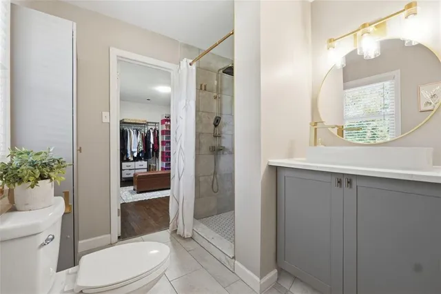 a bathroom with a toilet a sink and shower