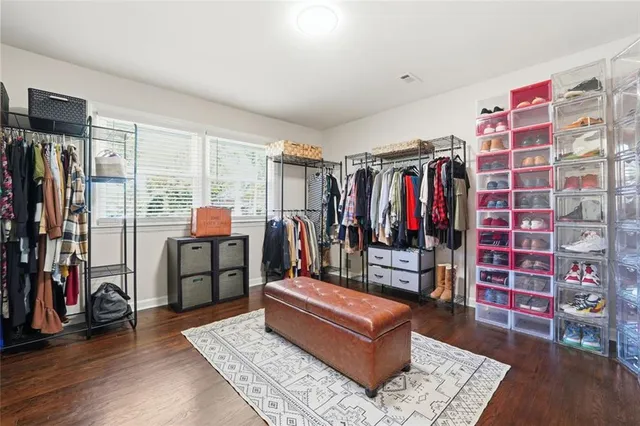 a living room with furniture a flat screen tv and a rug