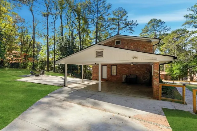a backyard of a house with yard and outdoor seating