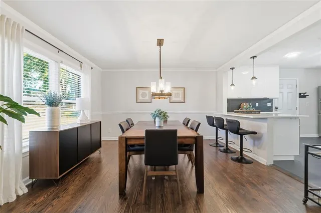 a view of a dining room with furniture window and wooden floor