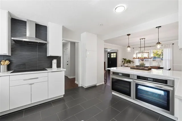 a kitchen with stainless steel appliances white cabinets and a stove