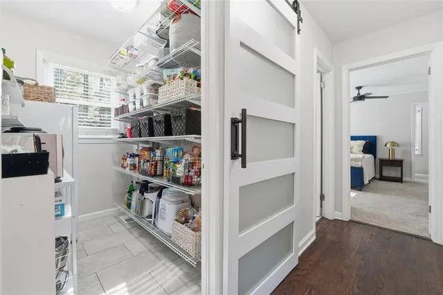 a view of a hallway with workspace and a living room