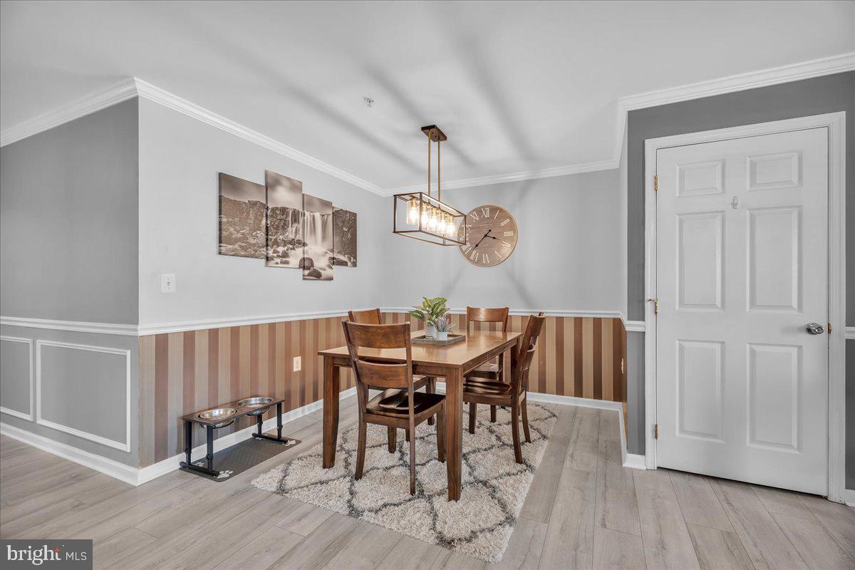 207 Redbud Lane, Unit 207 Mantua, NJ 08051 - Photo 12 of 22 a view of a dining room with furniture and wooden floor