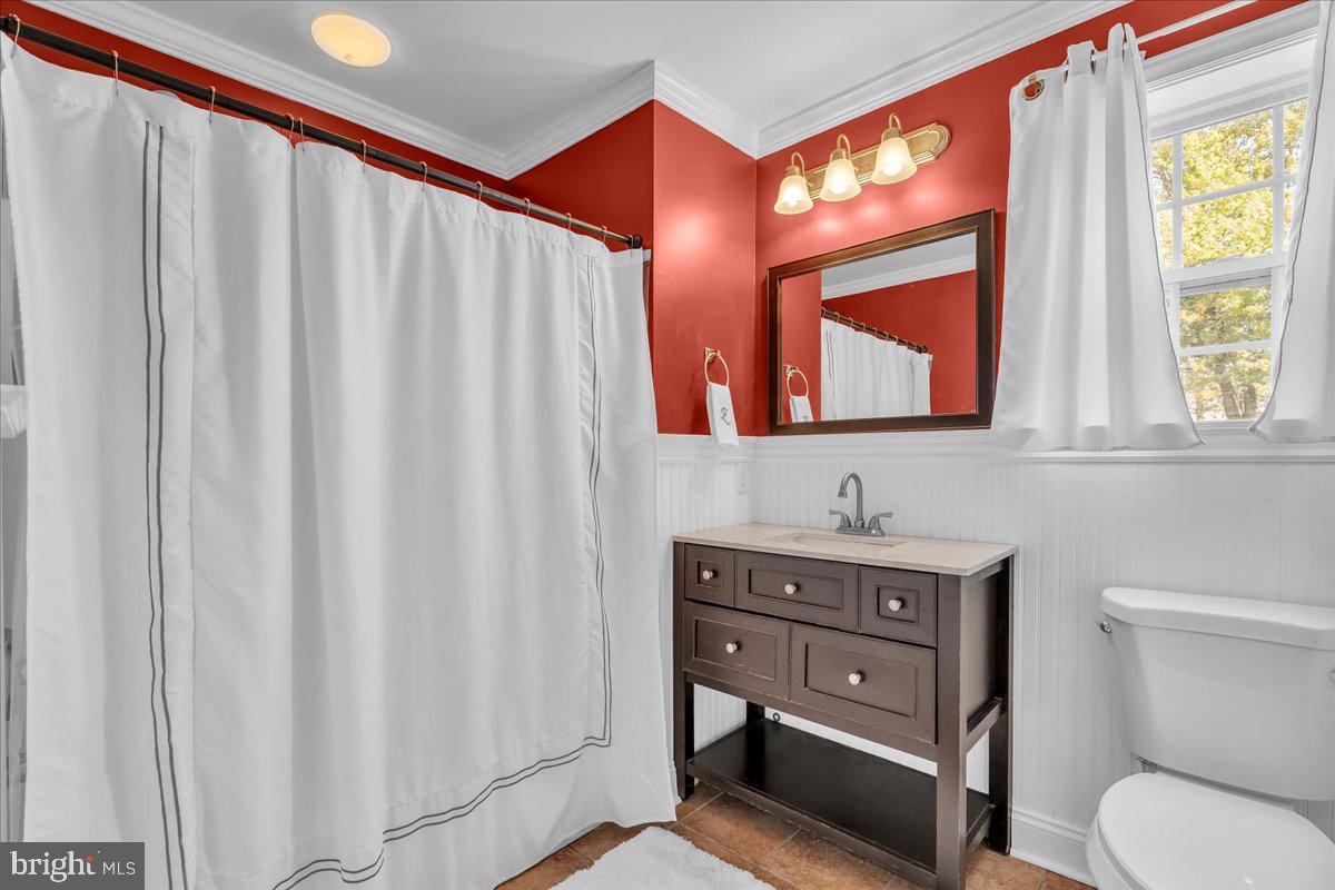 207 Redbud Lane, Unit 207 Mantua, NJ 08051 - Photo 14 of 22 a bathroom with a toilet a sink and a mirror