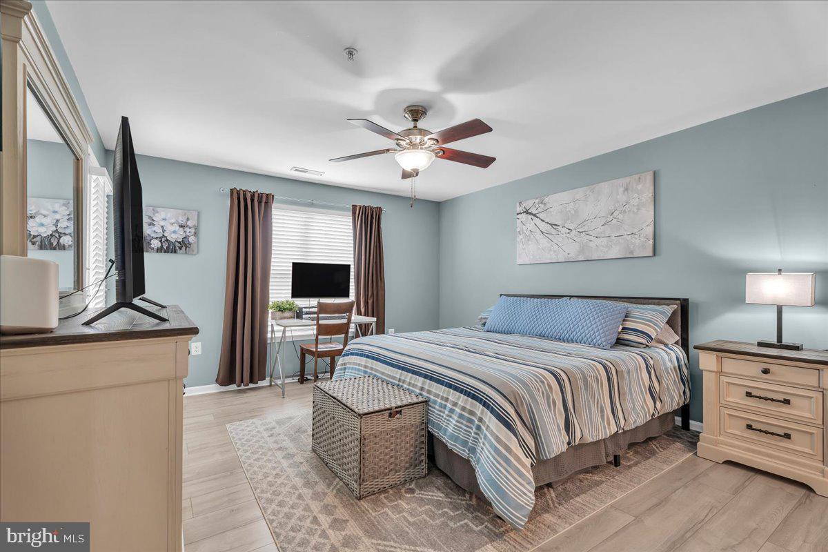 207 Redbud Lane, Unit 207 Mantua, NJ 08051 - Photo 17 of 22 a bedroom with a bed and a chandelier