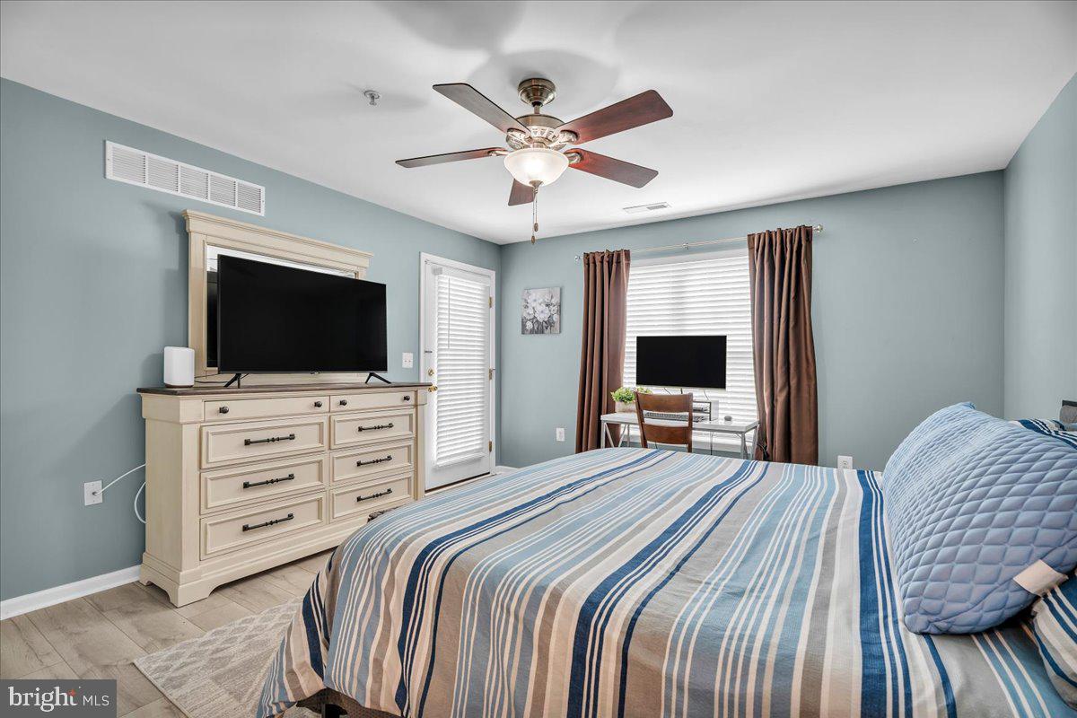 207 Redbud Lane, Unit 207 Mantua, NJ 08051 - Photo 18 of 22 a bedroom with a bed and a flat screen tv
