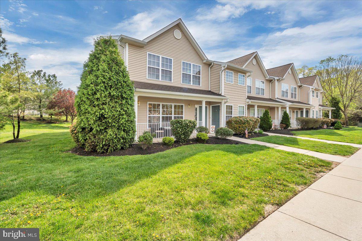 207 Redbud Lane, Unit 207 Mantua, NJ 08051 - Photo 2 of 22 a front view of a house with a yard