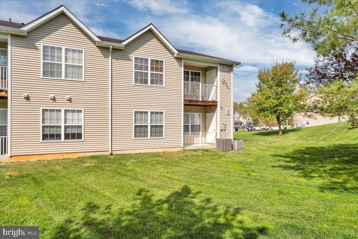 207 Redbud Lane, Unit 207 Mantua, NJ 08051 - Photo 21 of 22 a front view of a house with a yard