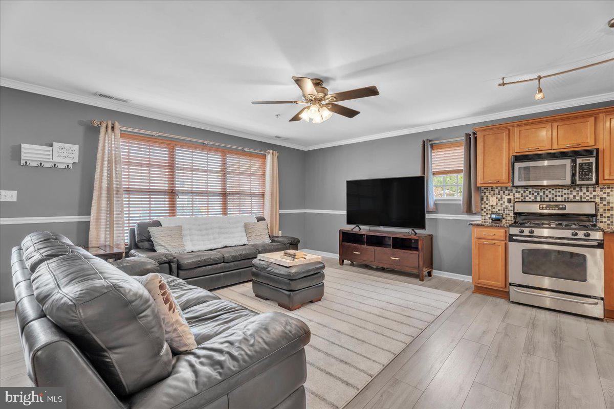 207 Redbud Lane, Unit 207 Mantua, NJ 08051 - Photo 5 of 22 a living room with furniture and a flat screen tv