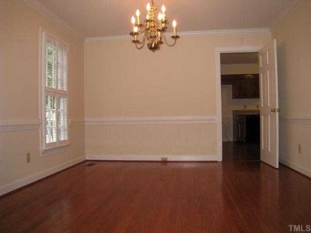 2408 Chello Court Raleigh, NC 27612 - Photo 3 of 10 wooden floor in an empty room with a window