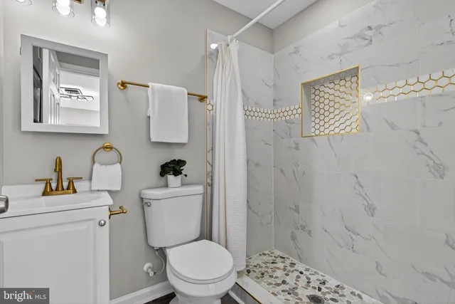 a bathroom with a toilet sink and shower