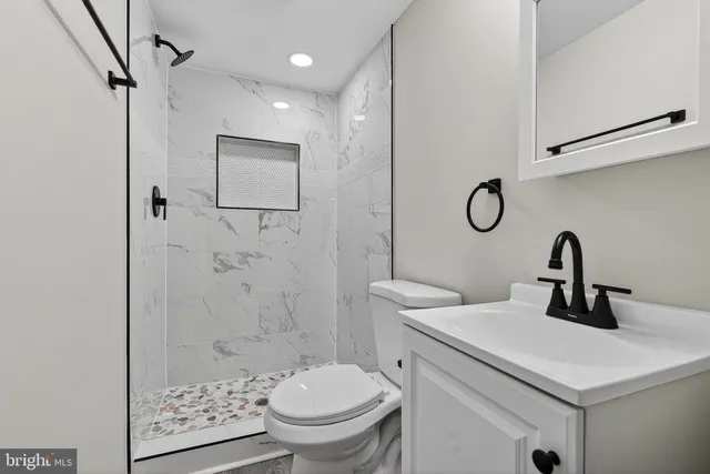 a bathroom with a sink toilet and shower