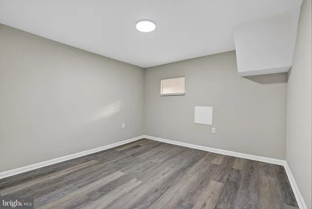 a view of room with wooden floor and fan
