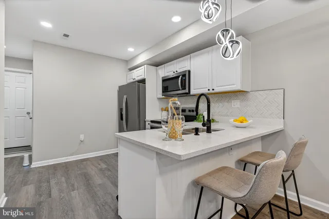 a kitchen with a sink cabinets and refrigerator