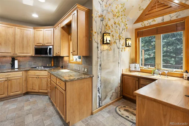 a kitchen with a stove a sink and a refrigerator