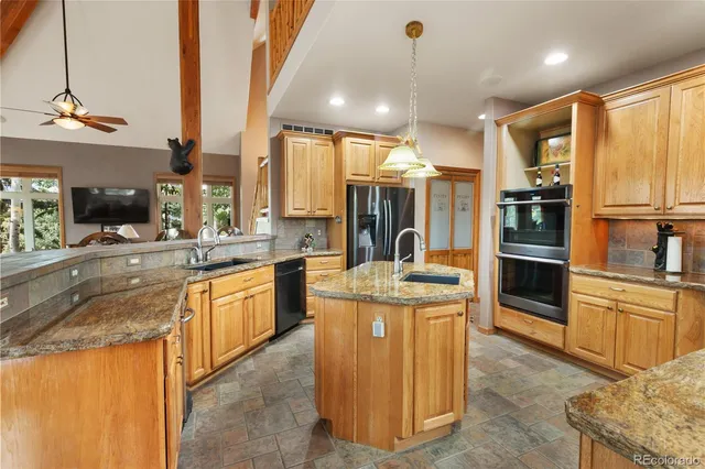 a kitchen with stainless steel appliances granite countertop a stove and a sink
