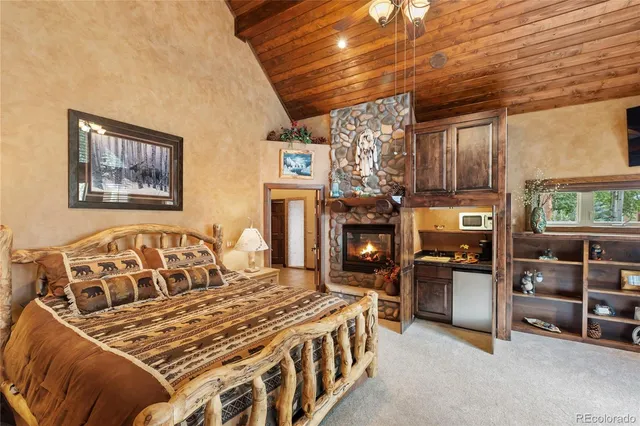 a bedroom with a bed and a fireplace