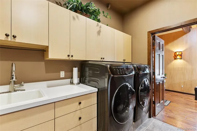 a utility room with sink dryer and washer