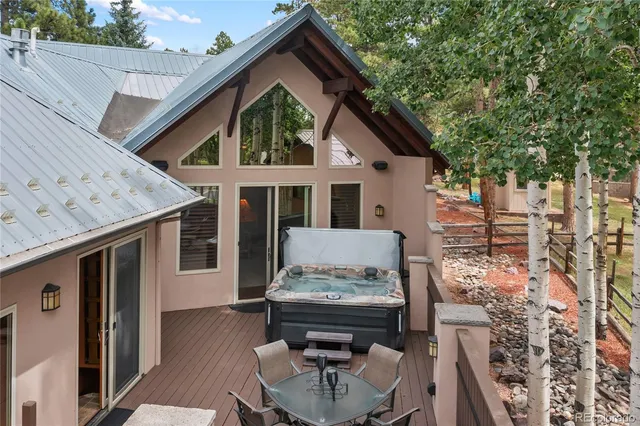 a view of a house with backyard and sitting area