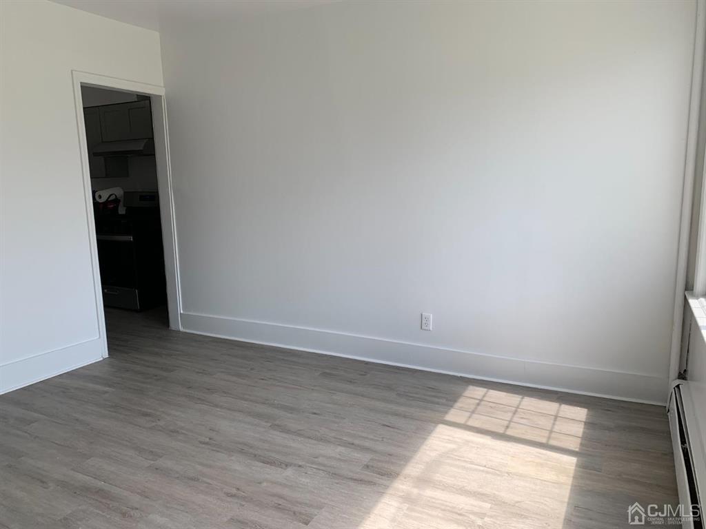13 Melbourne Court, Unit 1 Woodbridge, NJ 07095 - Photo 5 of 11 a view of an empty room and window