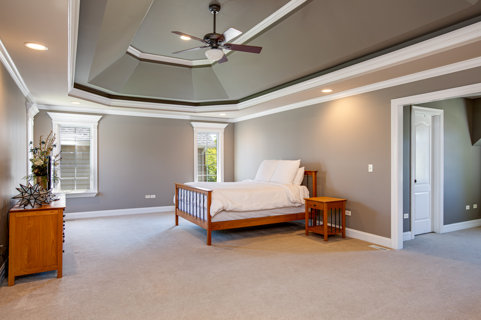 3976 Bluejay Lane Naperville, IL 60564 - Photo 14 of 34 a spacious bedroom with a bed and a chandelier