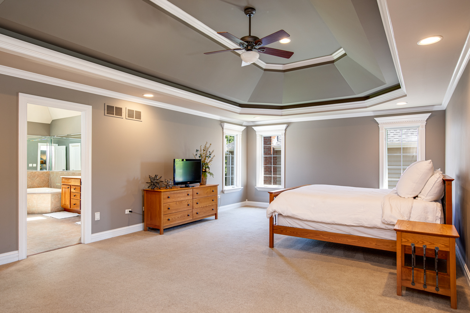 3976 Bluejay Lane Naperville, IL 60564 - Photo 15 of 34 a bedroom with a bed and a chandelier