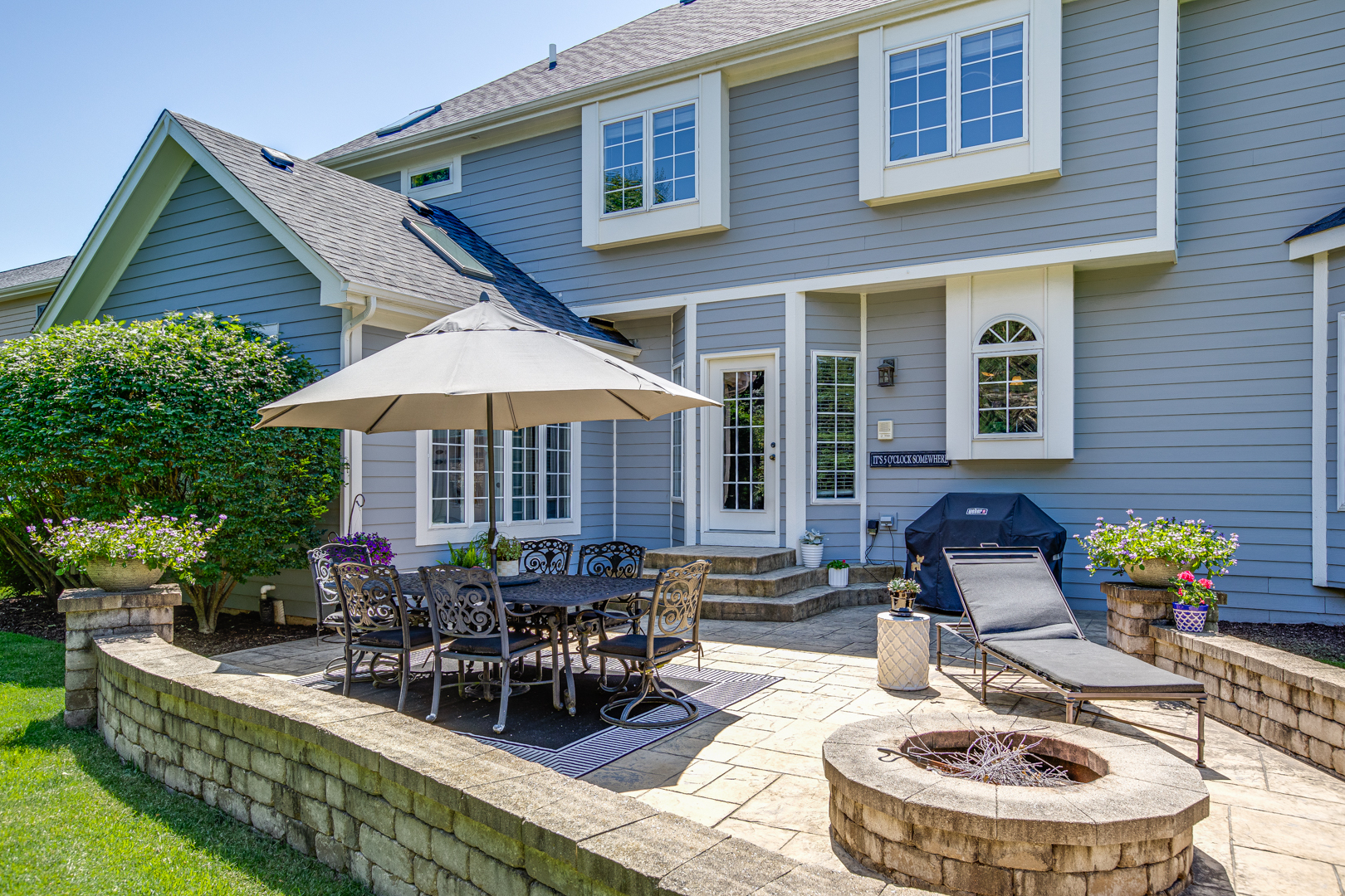 3976 Bluejay Lane Naperville, IL 60564 - Photo 30 of 34 a view of a patio with couches table and chairs under an umbrella