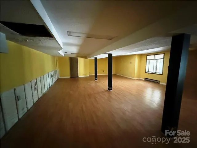 a view of a livingroom with an empty space and a window