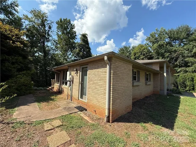 a front view of house with yard and trees