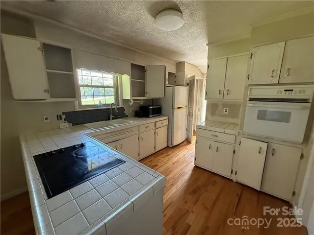 a kitchen with stainless steel appliances a stove a sink and a refrigerator
