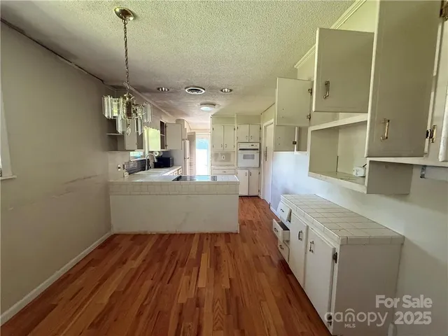 a kitchen with sink cabinets and wooden floor