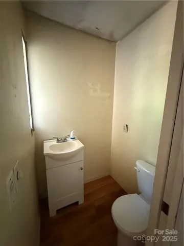 a bathroom with a sink and mirror with toilet