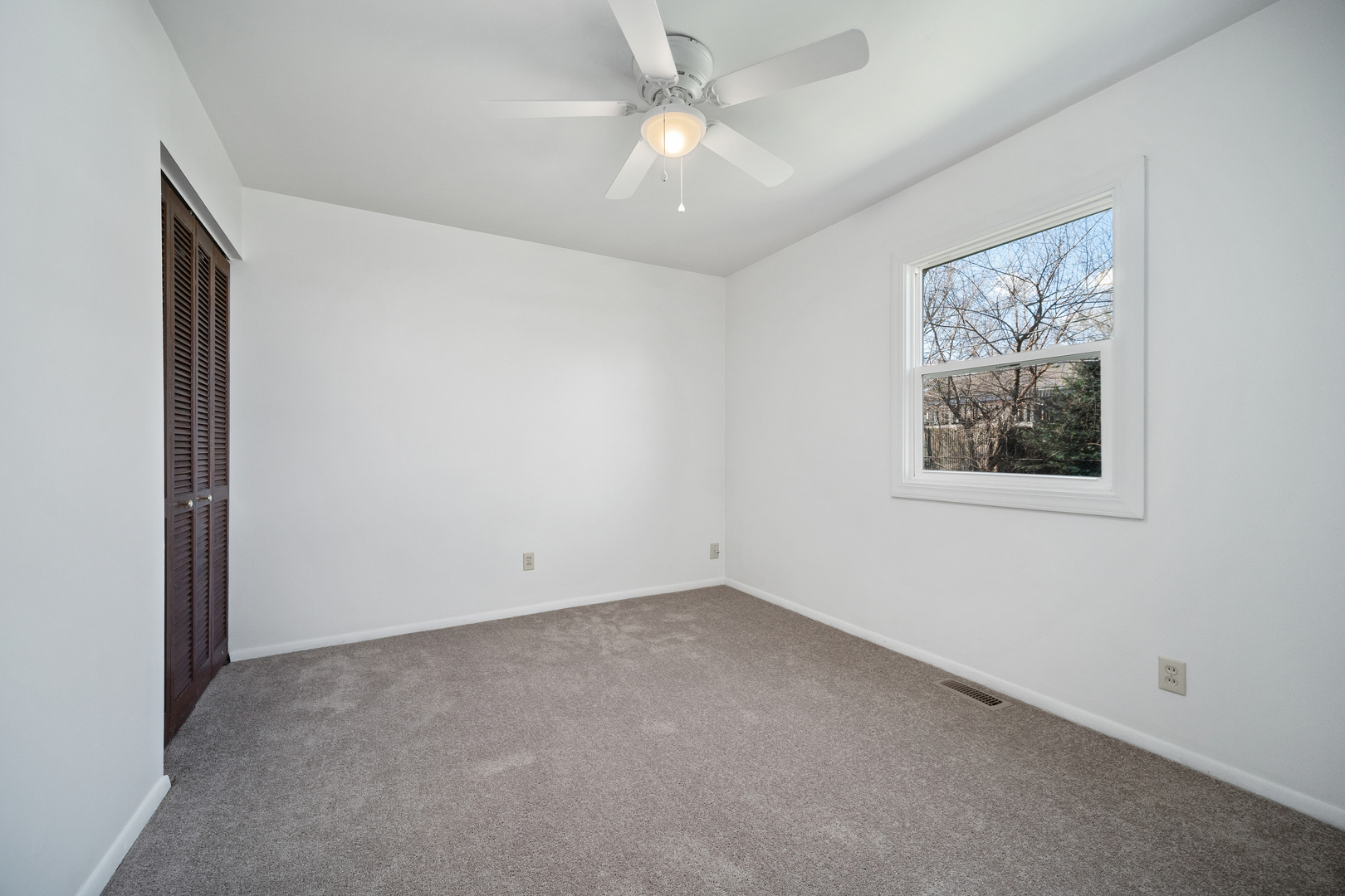 149 Mellbrook Road Bolingbrook, IL 60440 - Photo 11 of 17 an empty room with windows and fan